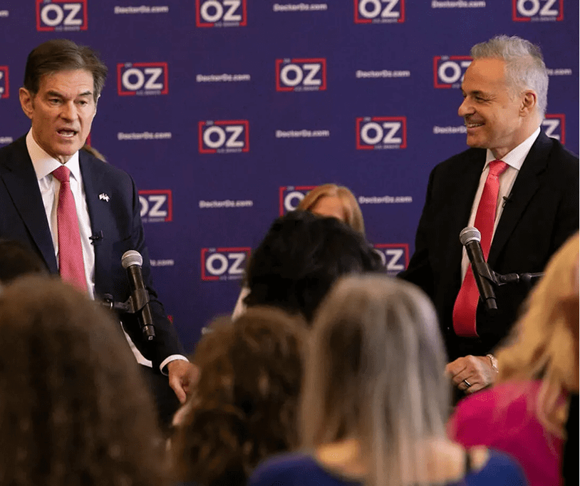 Two men speaking at an event