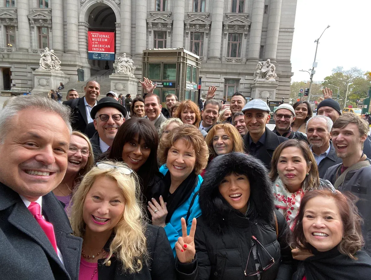 Group selfie in front of historic building