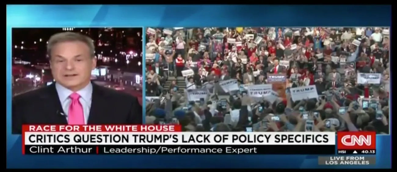Crowd at political rally shown on screen