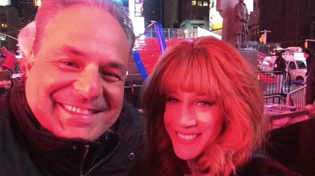 Smiling duo in vibrant city lights