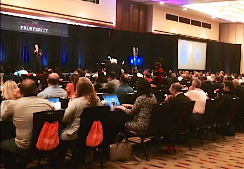 Conference attendees listening to a speaker