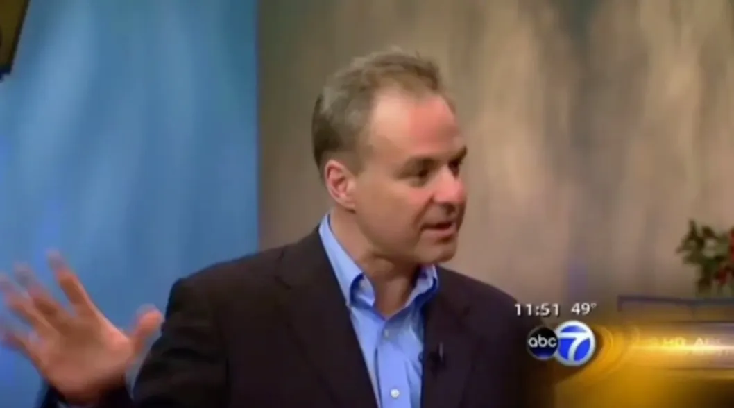 Person gesturing during TV broadcast