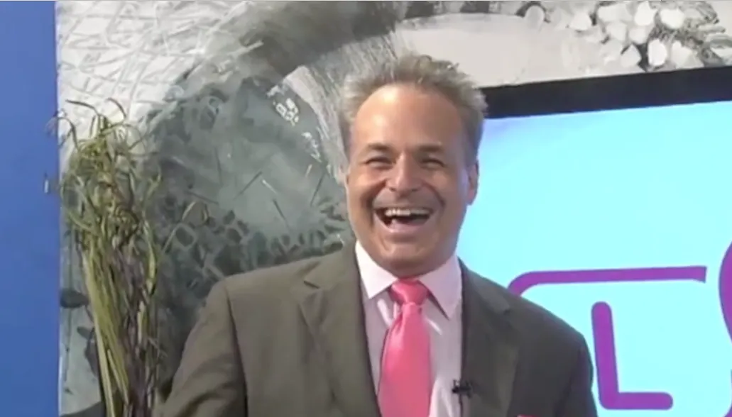 Smiling man in suit and pink tie