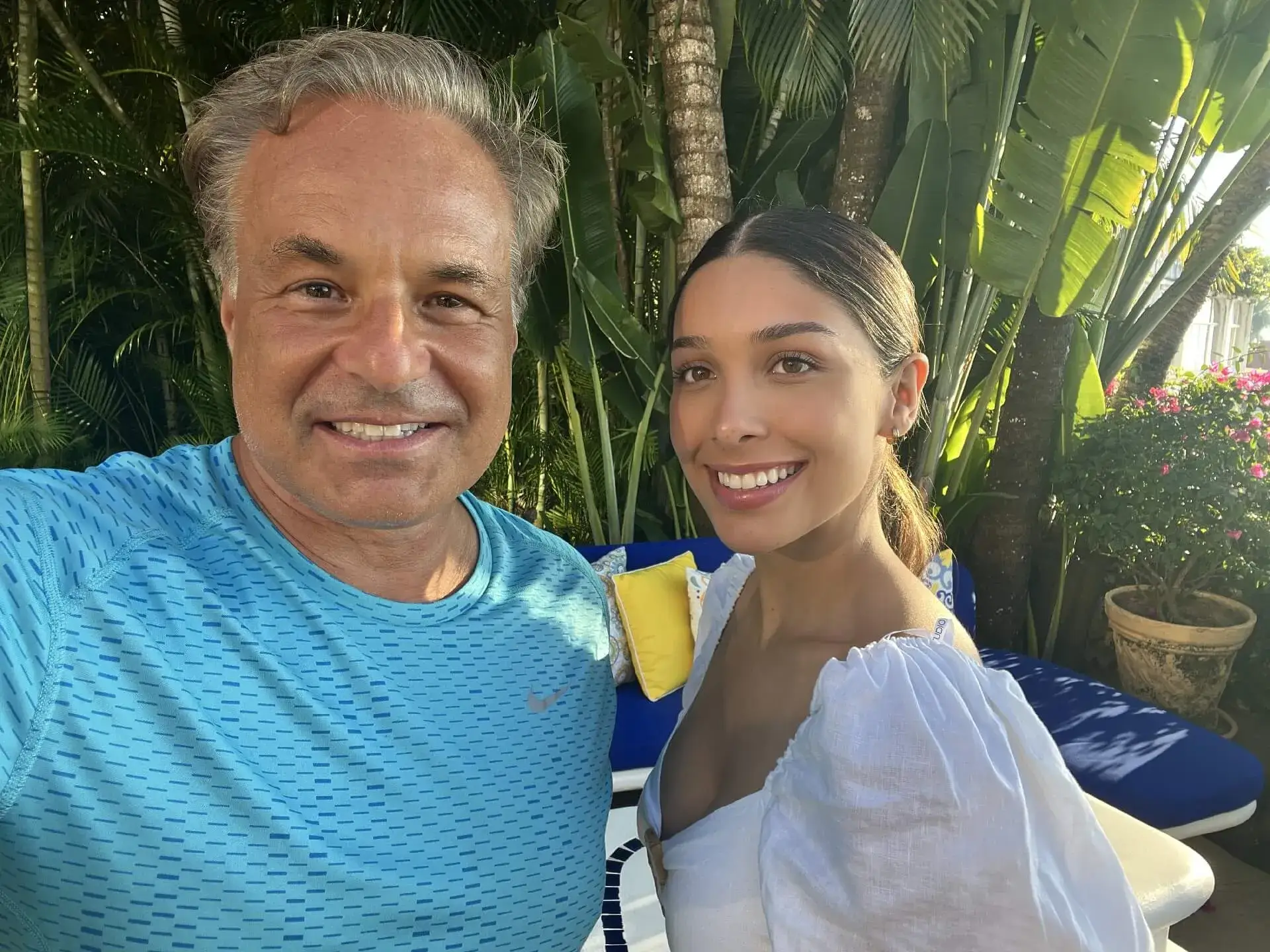Happy duo posing in tropical setting