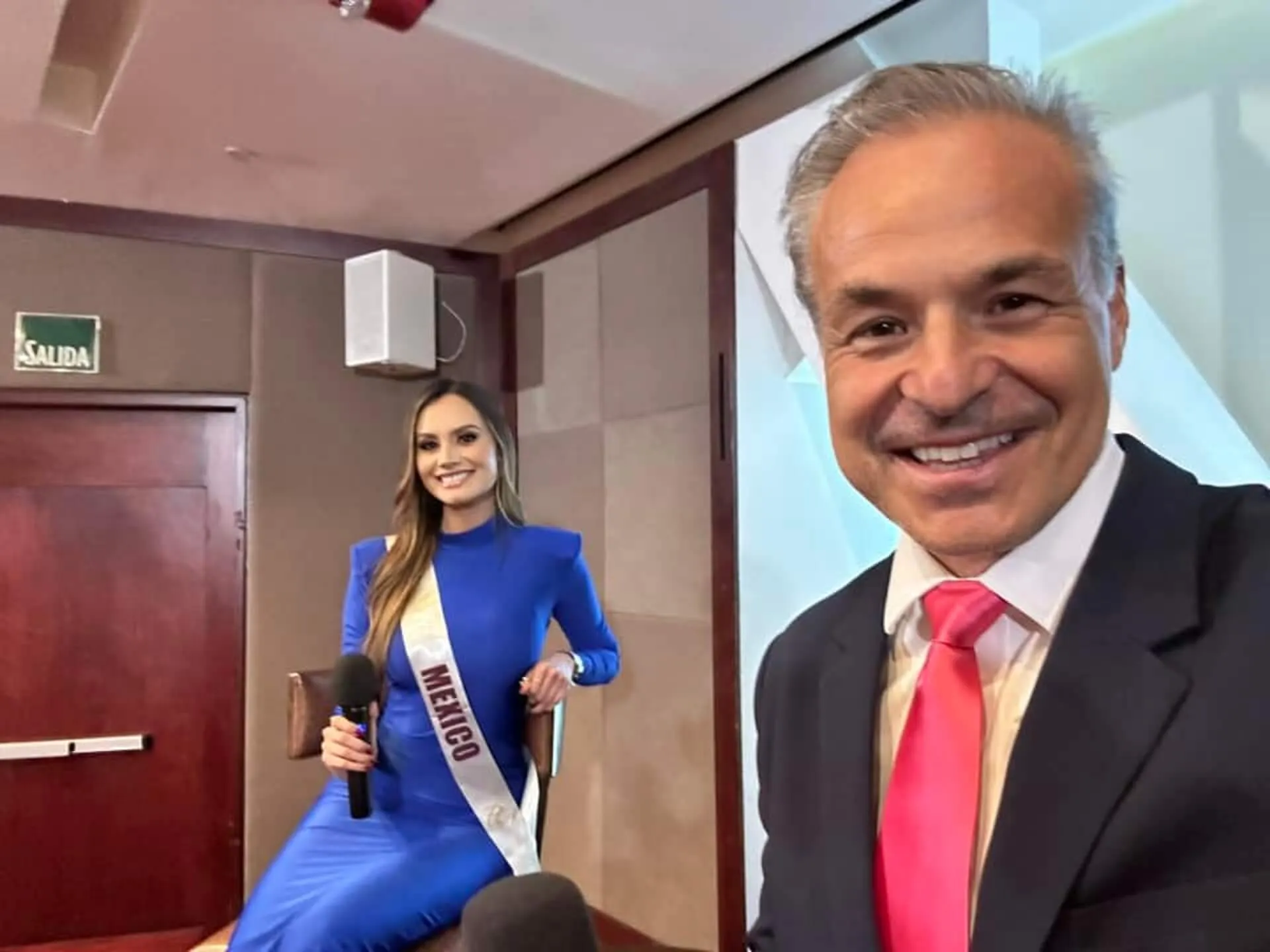Smiling duo at an indoor event